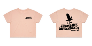 Pink Crop Top With a Groovy font print on the left chest "Snowbird Botanicals Barnet, VT" and a bigger version on the back with a snowbird added above.