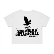Load image into Gallery viewer, White Crop Top with a big design on the back of a snowbird and the text &quot;Snowbird Botanicals Barnet, VT&quot; underneath.